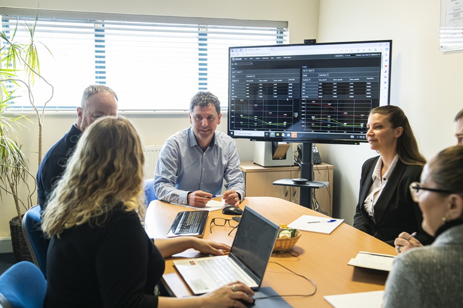 home Information Management People around a conference table